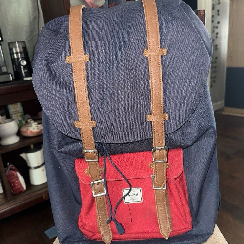 Herschel backpack with pocket. One button is missing, kept it in the front zip.